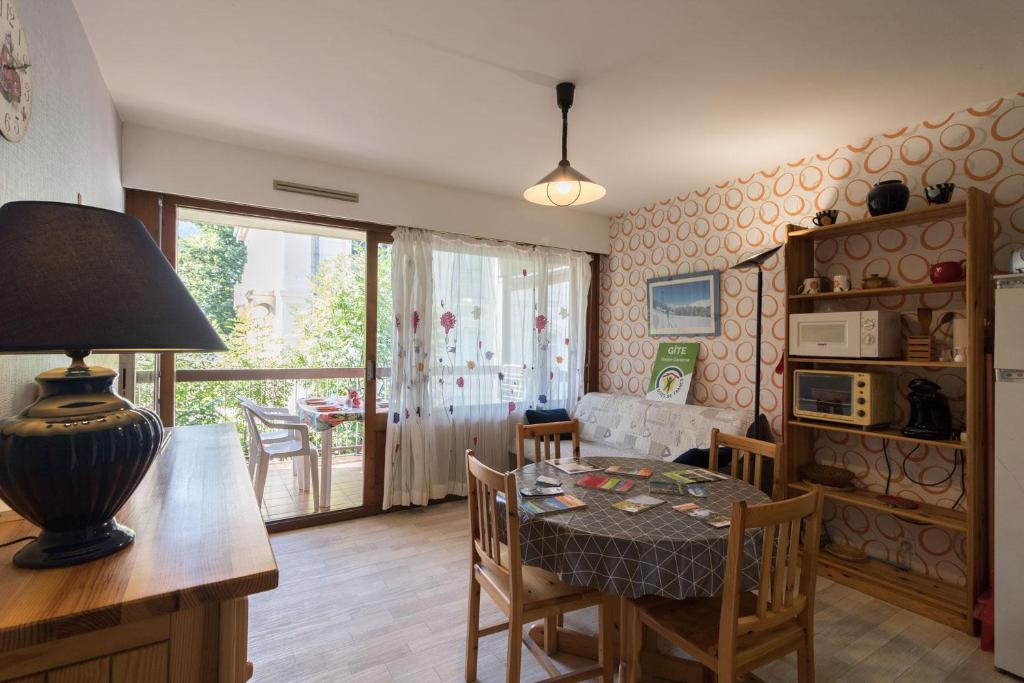a living room with a table and a dining room at Vacances cures luchon in Luchon