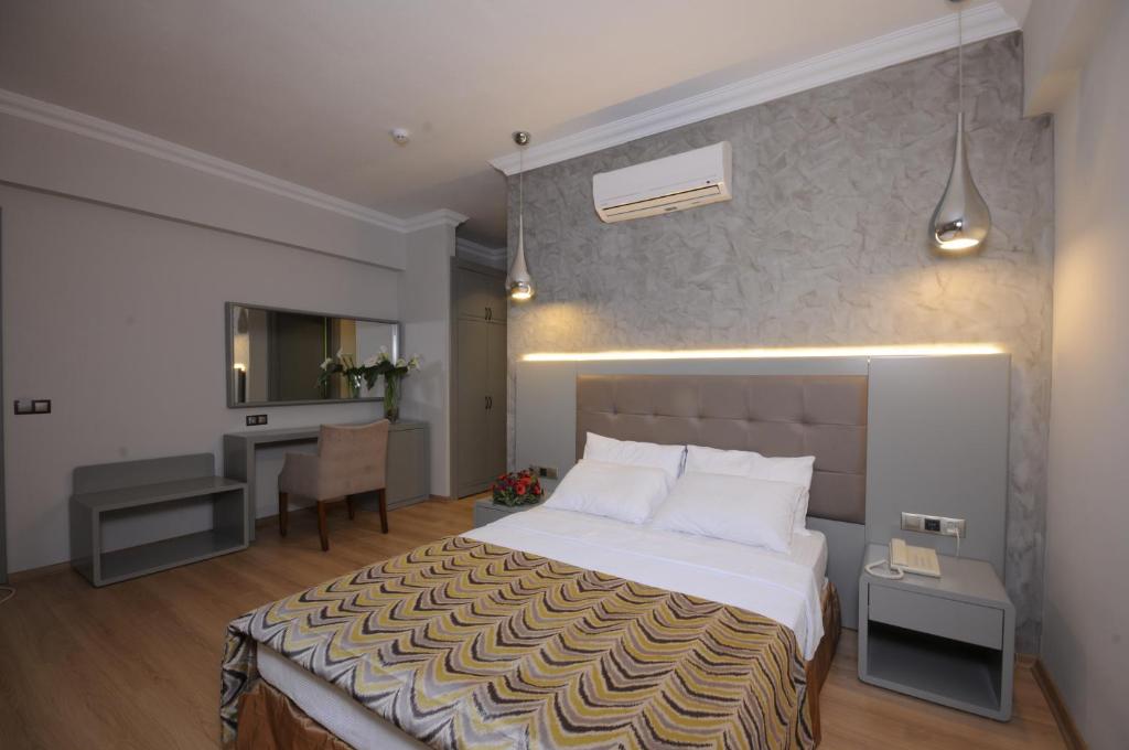 a hotel room with a bed and a desk at Pasa Garden Beach in Marmaris