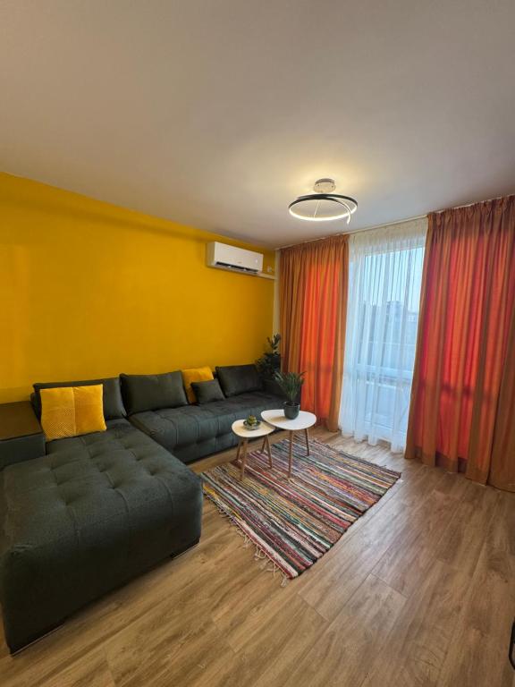 a living room with a couch and a table at Sinemorets Blue apartments in Sinemorets