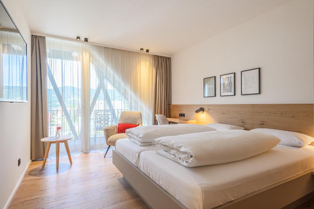 Postel nebo postele na pokoji v ubytování Hotel Die Alm