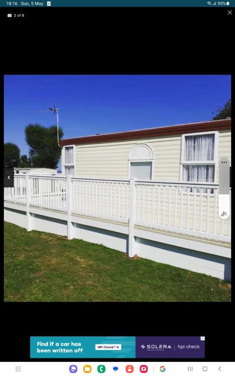 a white fence in front of a house at Cosy holiday home in Warden
