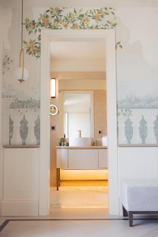 a bathroom with a white sink and a mirror at Hotel Belvedere in Forte dei Marmi