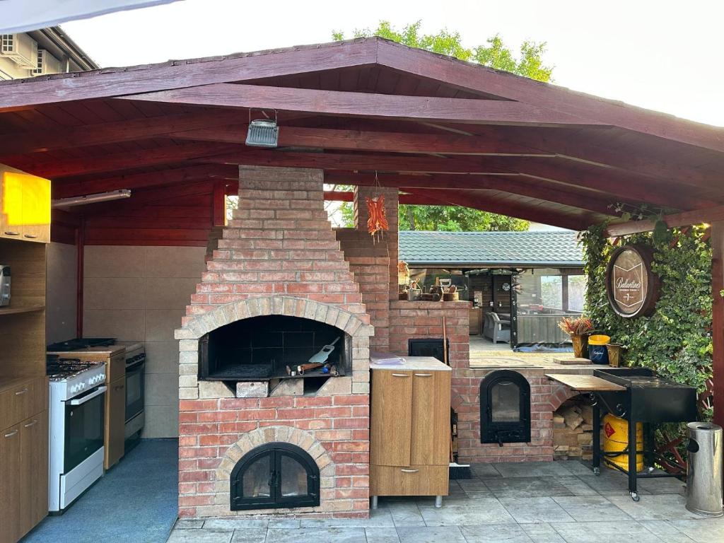 a patio with a brick oven in a backyard at Casa George in Costinesti