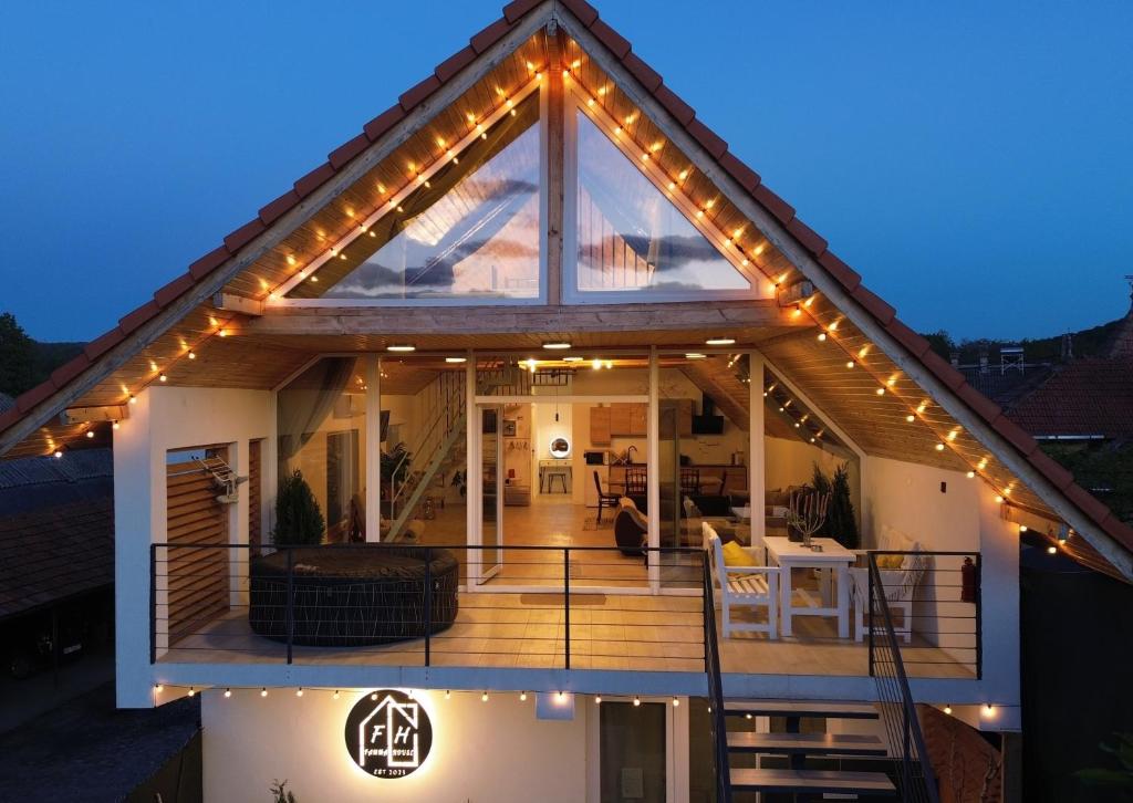 a house with lights on the roof at night at Famma House in Capu Piscului