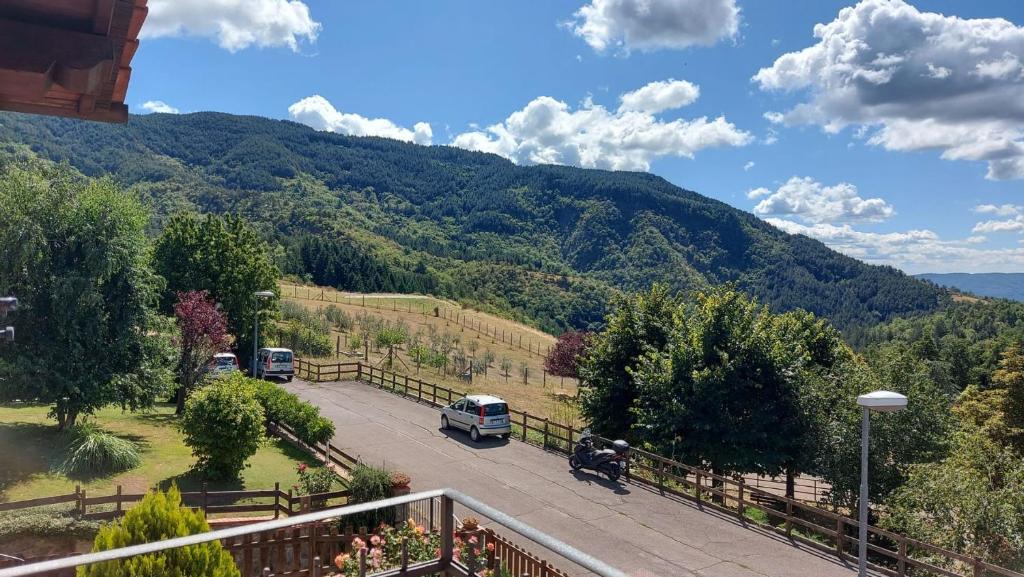 a view of a mountain with cars parked in a parking lot at Casa nel Parco delle Foreste Casentinesi in Moggiona