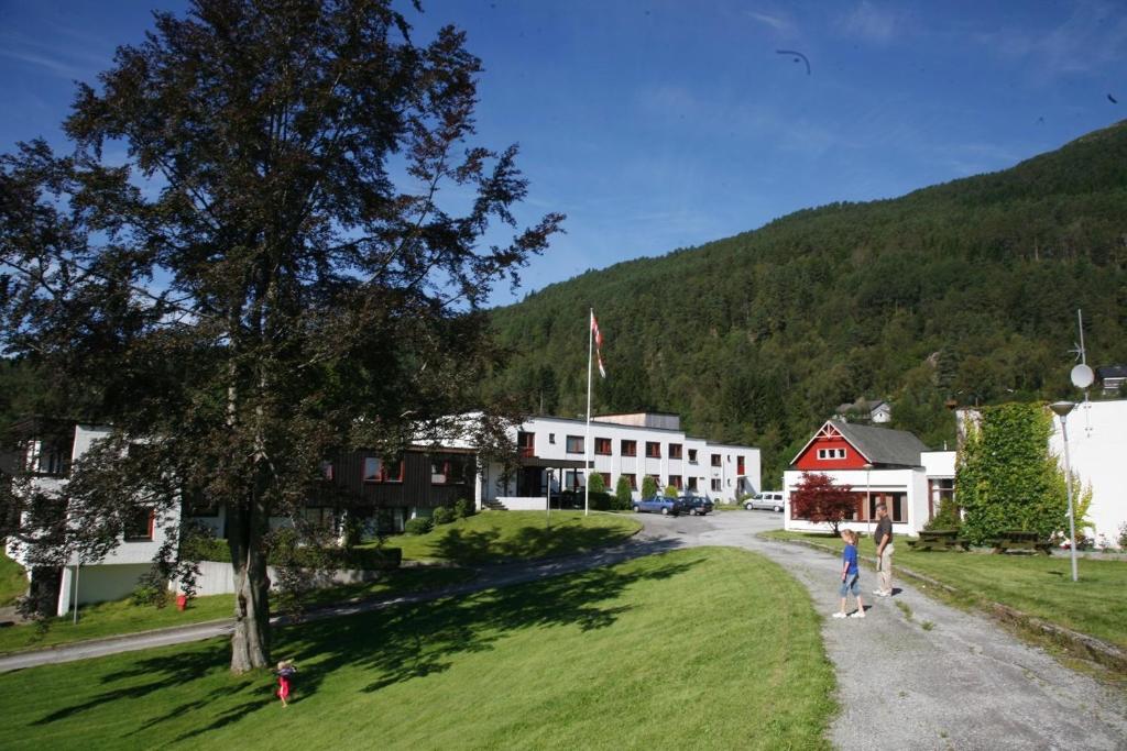 a group of people walking down a road in a small town at Førde Sommarhotell in Førde