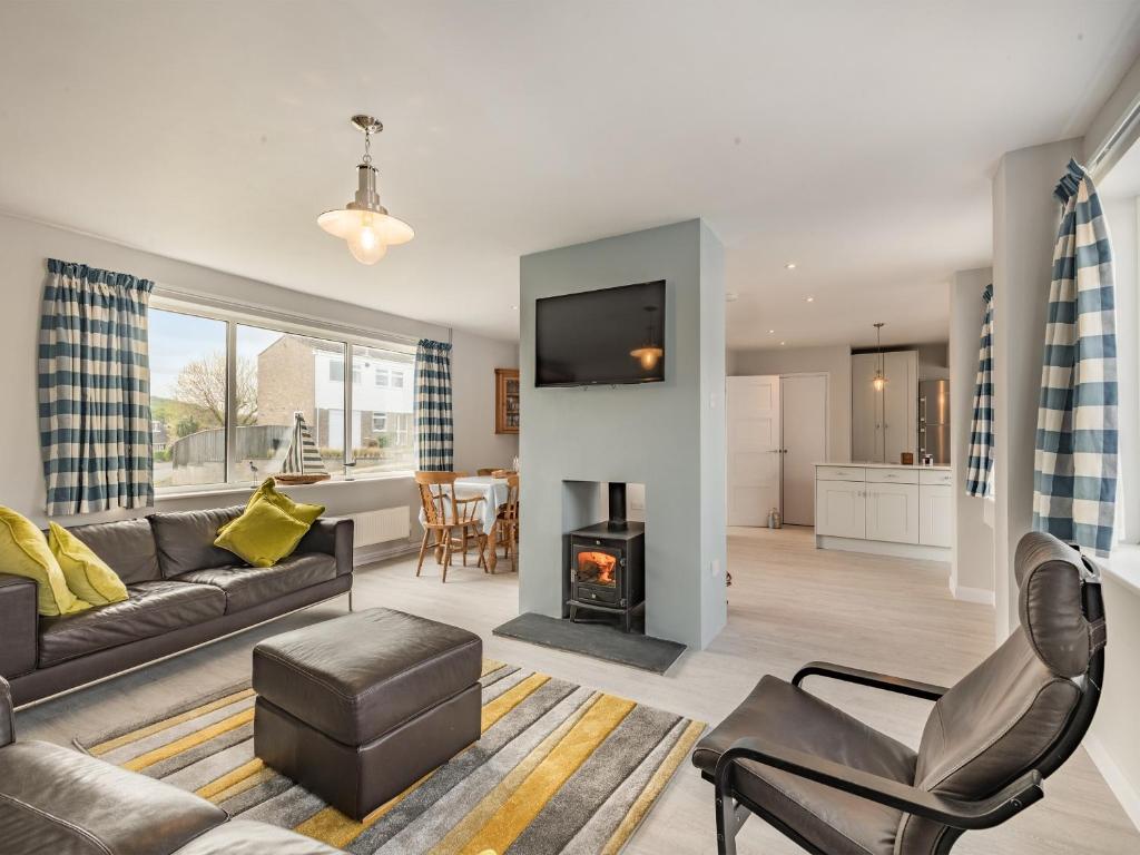 a living room with a couch and a fire place at Little Dab in Brancaster