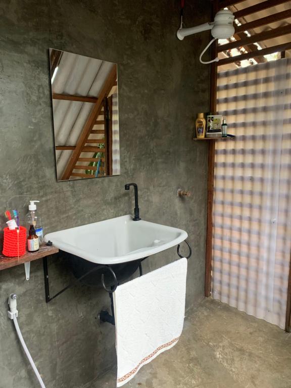 a bathroom with a sink and a mirror at Estudio Embira - Lago Verde in Santarém