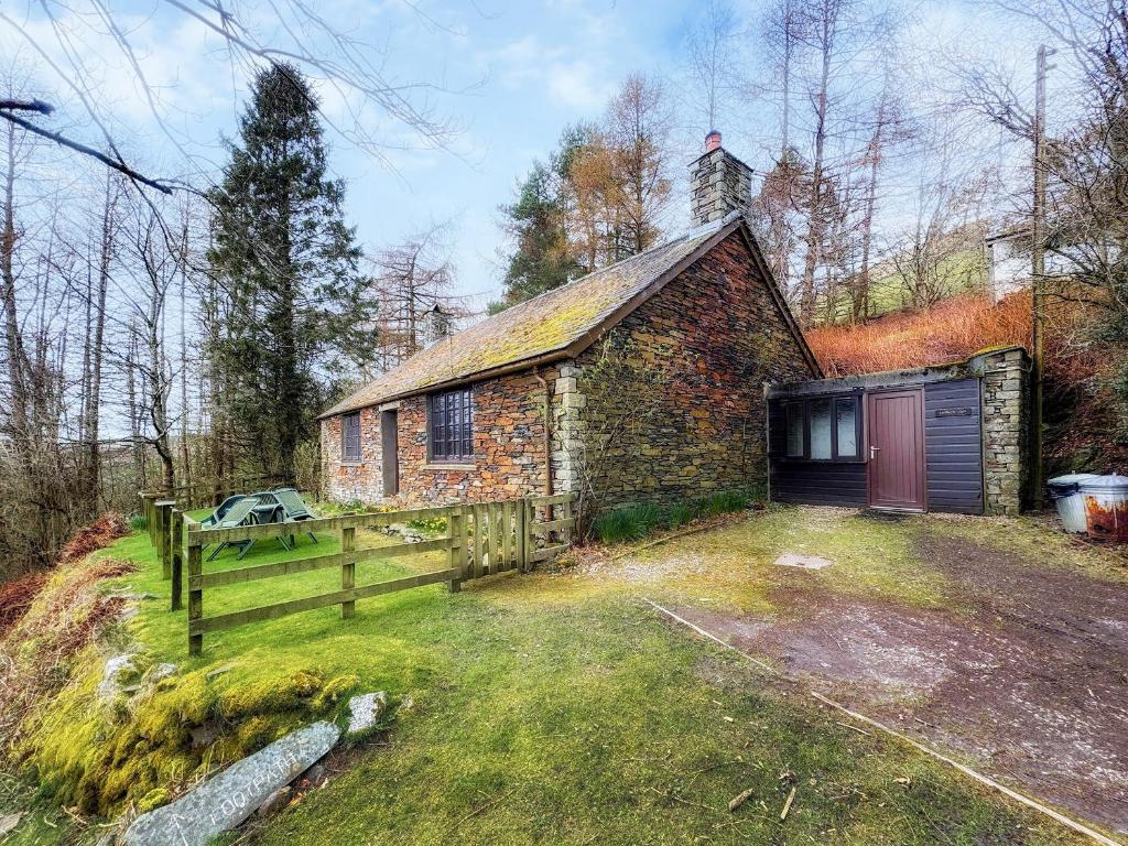 an old brick building with a gate and a fence at Latrigg View - Uk45177 in Threlkeld