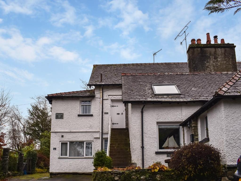 a white house with a chimney on top of it at Beeches in Windermere
