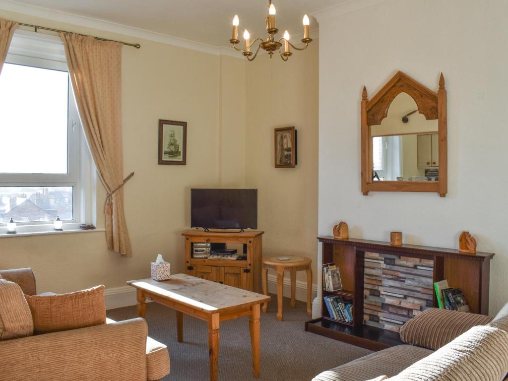 a living room with a couch and a tv at Seasider in Whitby