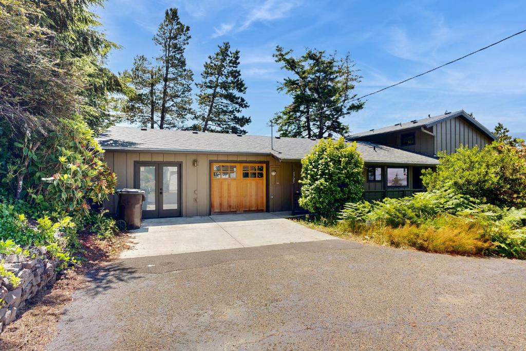a house with a garage with a driveway at Bayside Retreat in Netarts