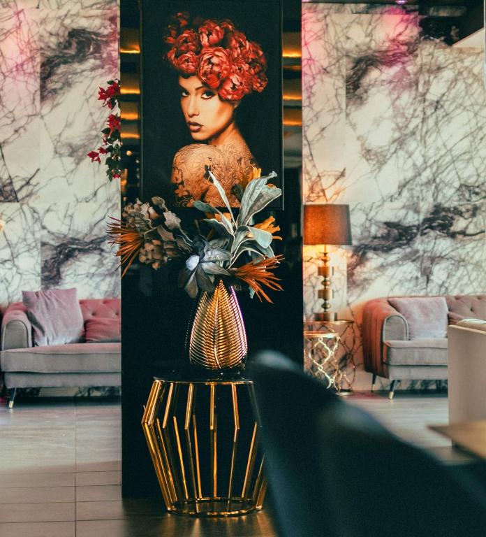 a vase of flowers on a table in a room at The Ciao Stelio Deluxe Boutique Hotel - Adults Only in Larnaka