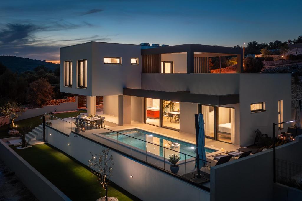 a large house with a swimming pool at night at Villa Svetog Vida in Sevid