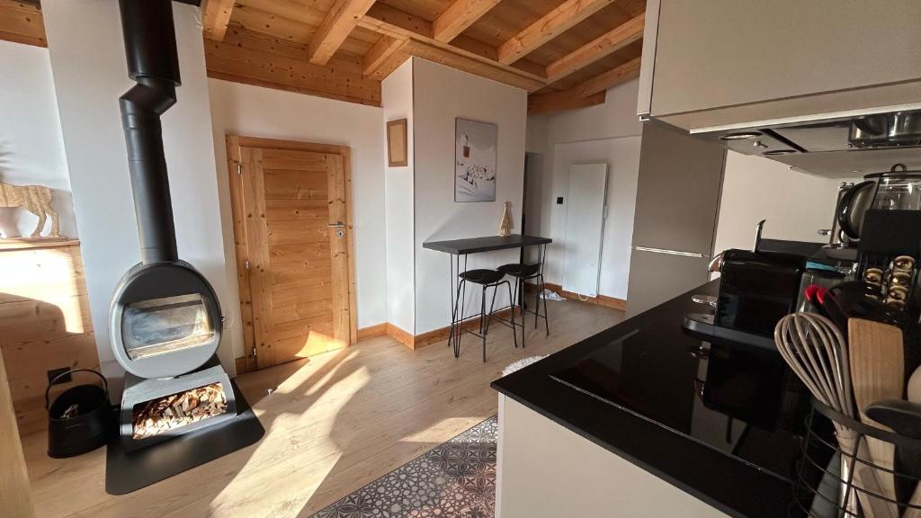 a kitchen with a stove in the middle of a room at Roof top Moutain view direct access Morzine Avoriaz in Montriond