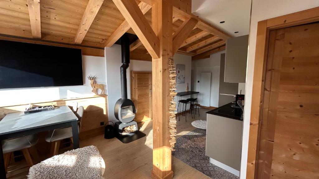 a living room with a large flat screen tv at Roof top Moutain view direct access Morzine Avoriaz in Montriond