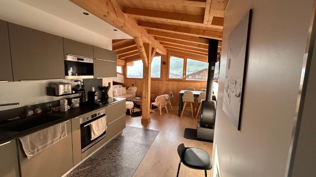 a kitchen with a counter and a dining room at Roof top Moutain view direct access Morzine Avoriaz in Montriond