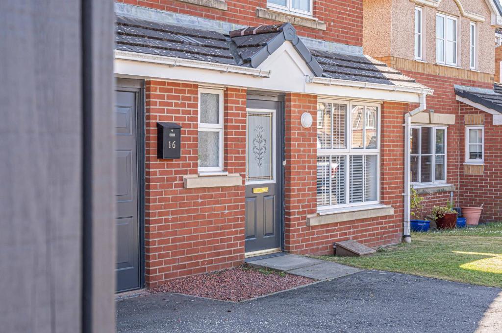 a red brick house with a door and windows at Super Prime Luxury 4 Bedroom Detached Home By Tba in Fife