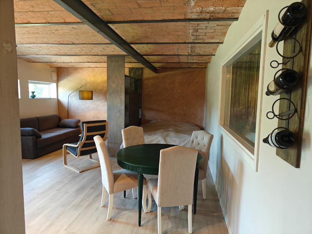 a room with a table and chairs and a couch at Sønderbygaard B&B in Årre
