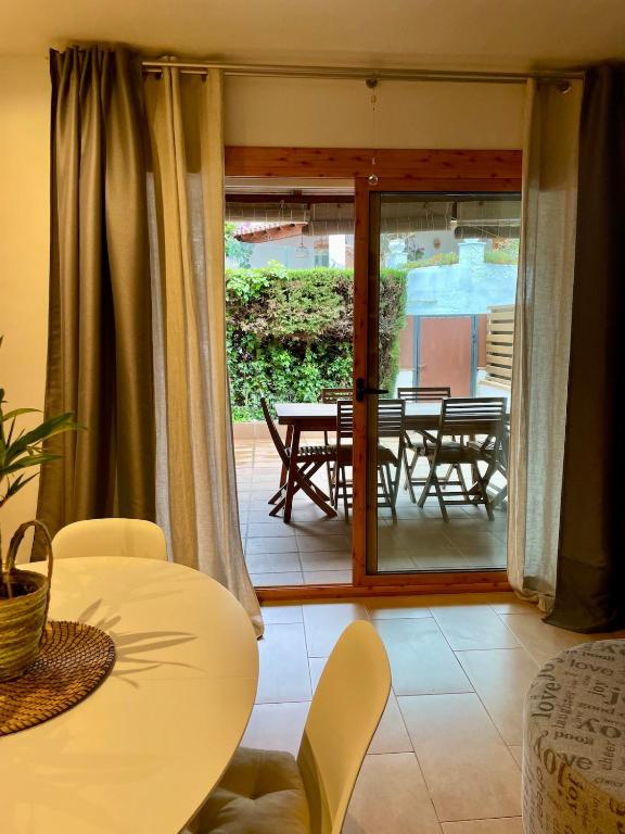 a living room with a table and chairs and a sliding glass door at Casa en Sant Antoni de Calonge in Calonge