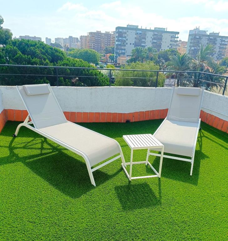 two lounge chairs and a table on a roof at Orange Park Duplex Atico Premium in Benicàssim