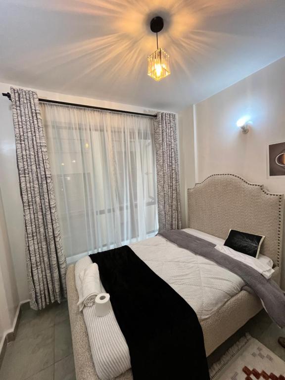 Postel nebo postele na pokoji v ubytování Tsavo Residence