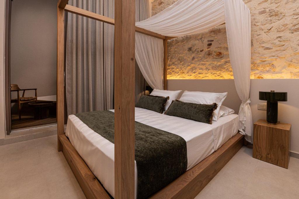 a bedroom with a bed with a canopy at Madonna del Mare City in Chania