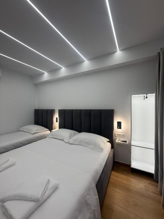 a bedroom with two beds in a room with at Hotel Barjami in Sarandë