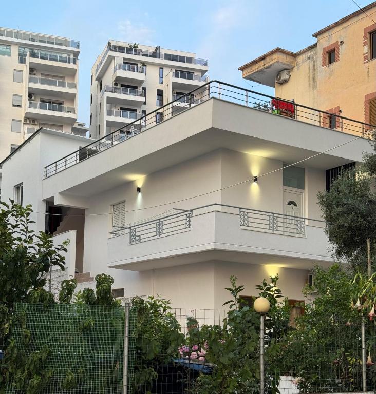 a white apartment building with a balcony at Hotel Barjami in Sarandë