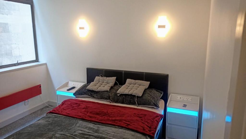 a bedroom with a bed with two pillows on it at GORGEOUS FlatD Central London Liverpool St Station in London
