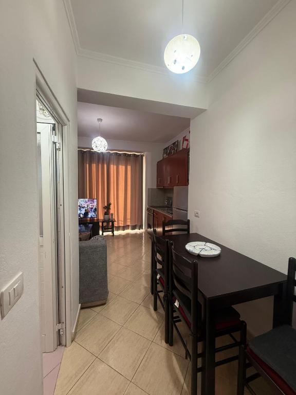 a kitchen and dining room with a table and chairs at Hotel Barjami in Sarandë