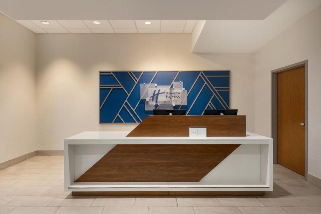 a lobby with a reception desk in a building at Holiday Inn Express Fort Lauderdale Airport South by IHG in Dania Beach