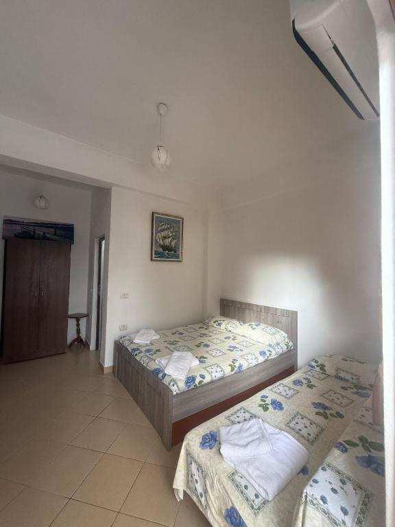 a bedroom with two beds in a room at Hotel Barjami in Sarandë