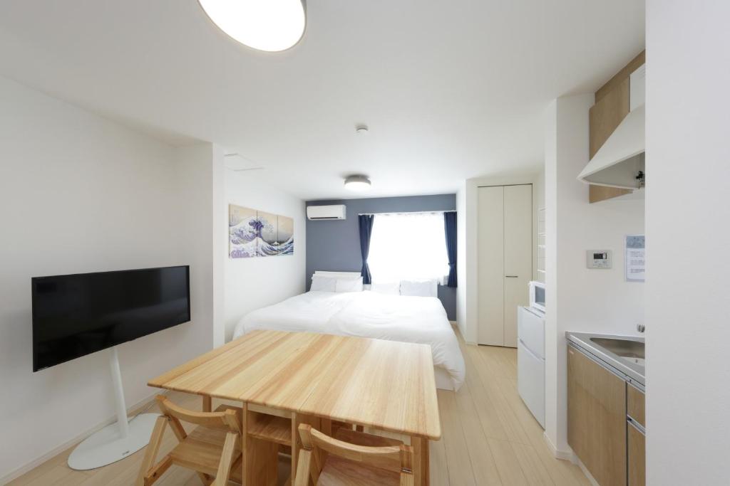 a bedroom with a bed and a wooden table at Rana Enoshima - Vacation STAY 84717v in Fujisawa