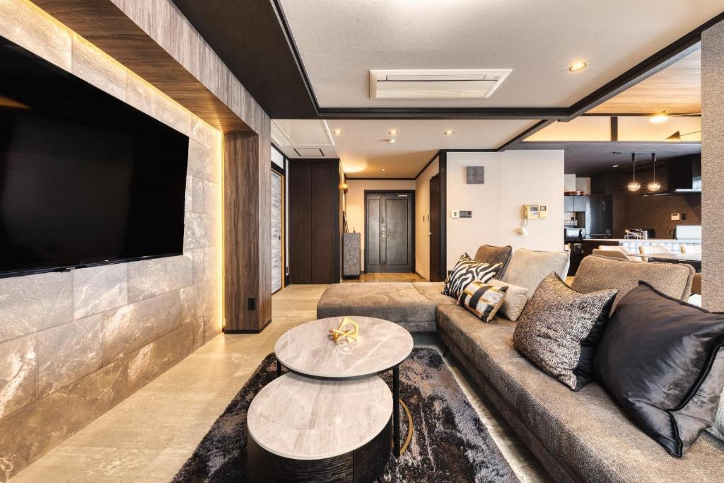 a living room with a couch and a tv at Taiho Square 7th floor - Vacation STAY 19139 in Osaka