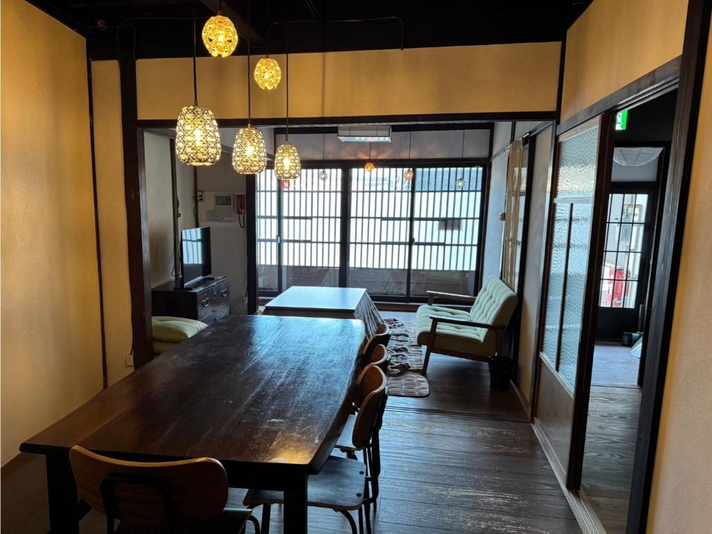 a dining room with a large wooden table and chairs at Tenjin Tabine - Vacation STAY 24241v in Kanazawa
