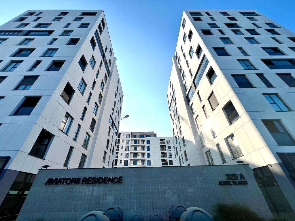 two tall white buildings next to each other at AVIATORII Modern Escape Apartment in Constanţa
