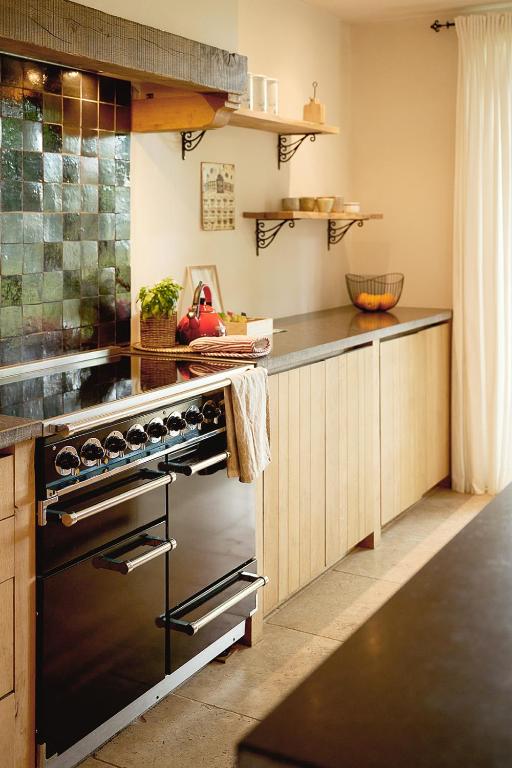 a kitchen with a black stove top oven at Muntershof in Velzeke-Ruddershove