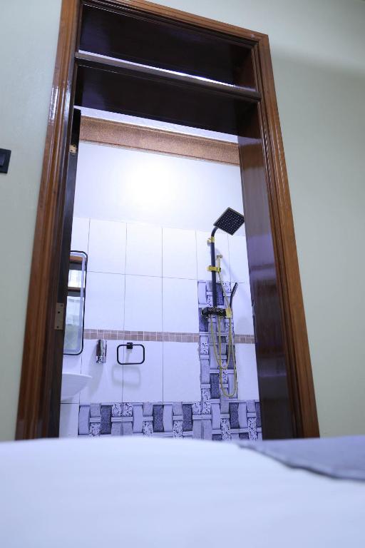 Postel nebo postele na pokoji v ubytování AG Home - Kampala