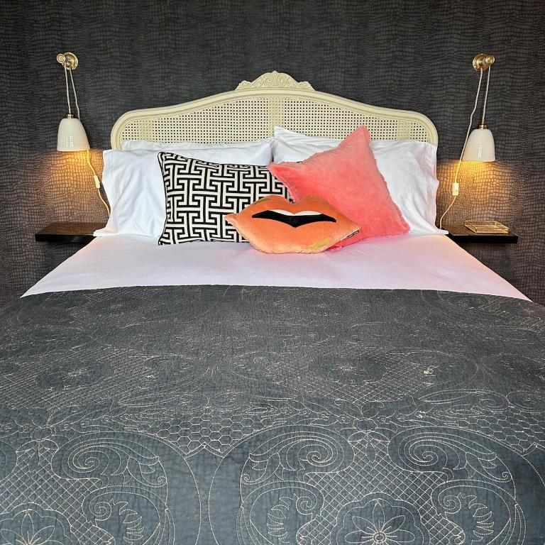 a bed with two pillows on top of it at No 6 Harrogate Luxury Boutique Home in Harrogate