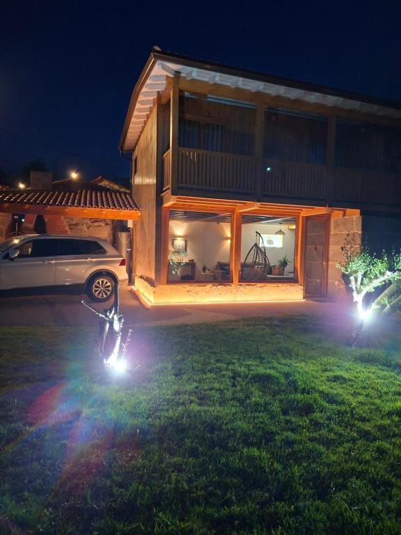 a motorcycle parked in front of a house at night at Casa Carballo in Puxedo