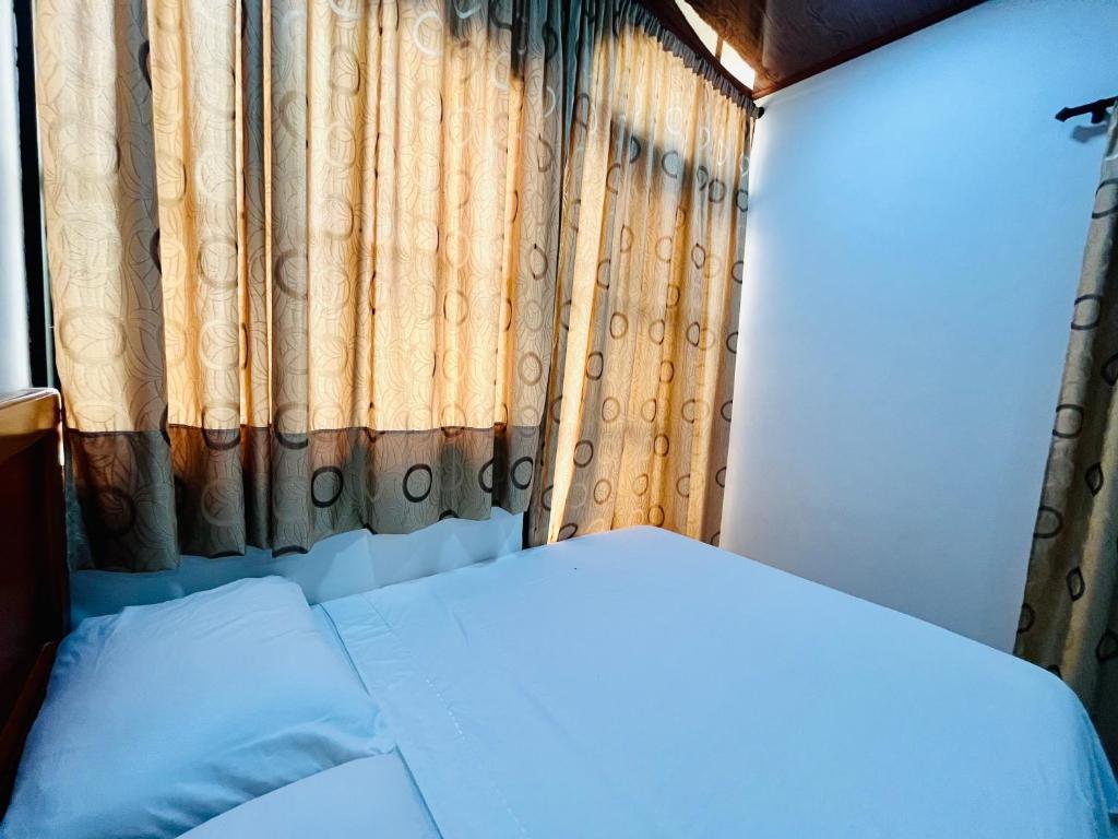 Postel nebo postele na pokoji v ubytování Aparta Hotel Horinthia