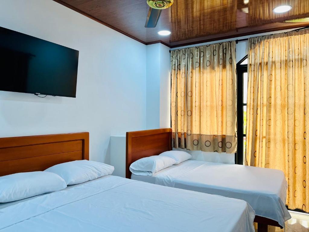 Postel nebo postele na pokoji v ubytování Aparta Hotel Horinthia