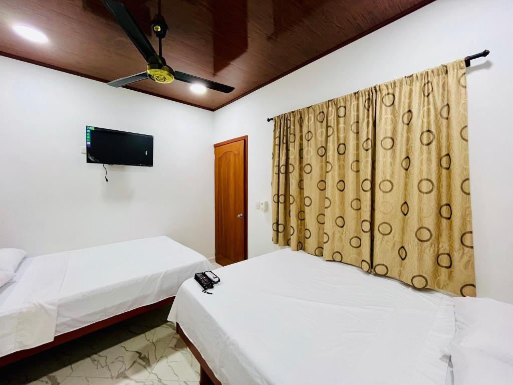 Postel nebo postele na pokoji v ubytování Aparta Hotel Horinthia