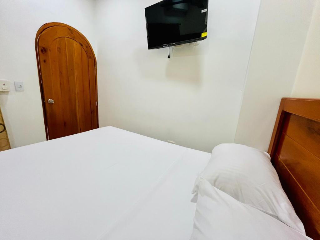 Postel nebo postele na pokoji v ubytování Aparta Hotel Horinthia
