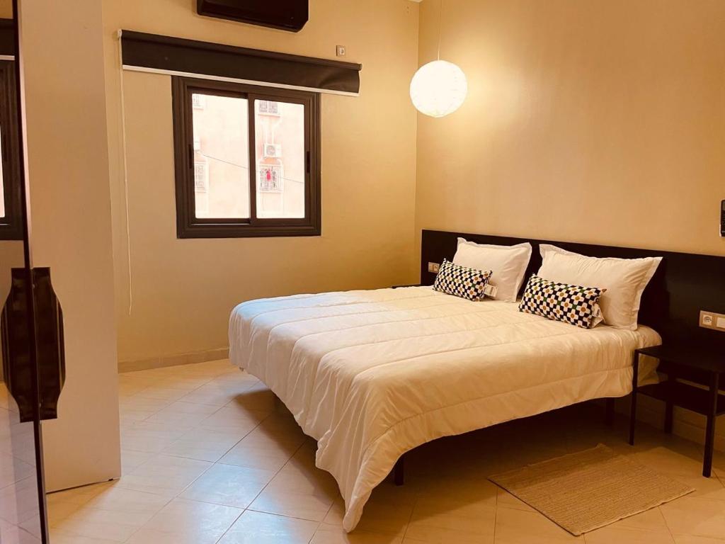a bedroom with a large bed with two pillows at Relax Family 04 - Cozy Entire Apartment in City Center in Ouarzazate