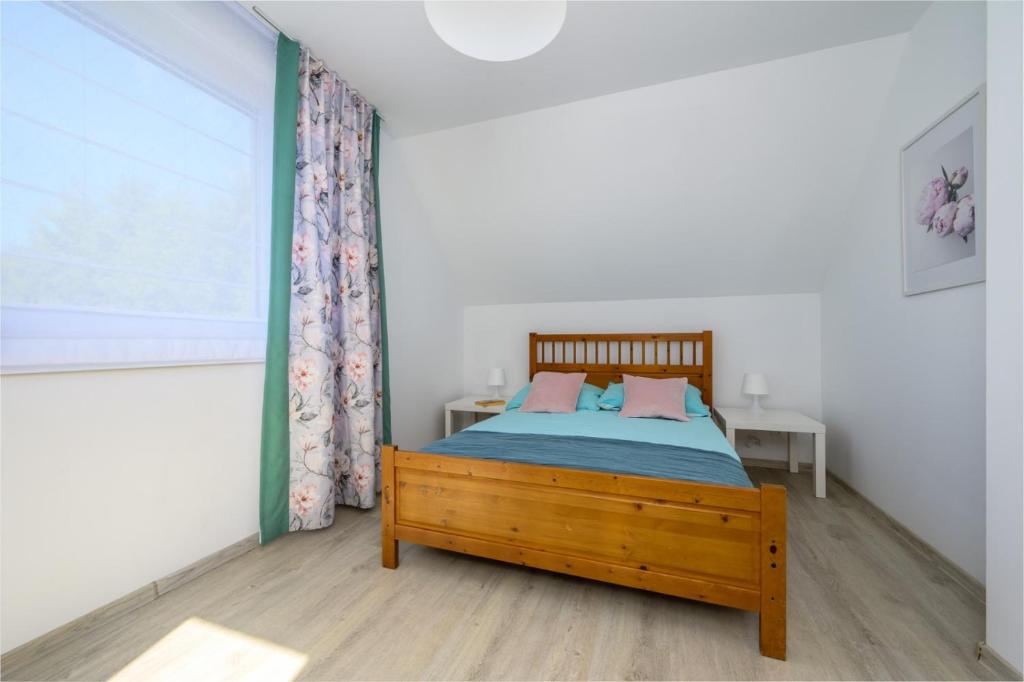 Postel nebo postele na pokoji v ubytování Domki Marina nad morzem