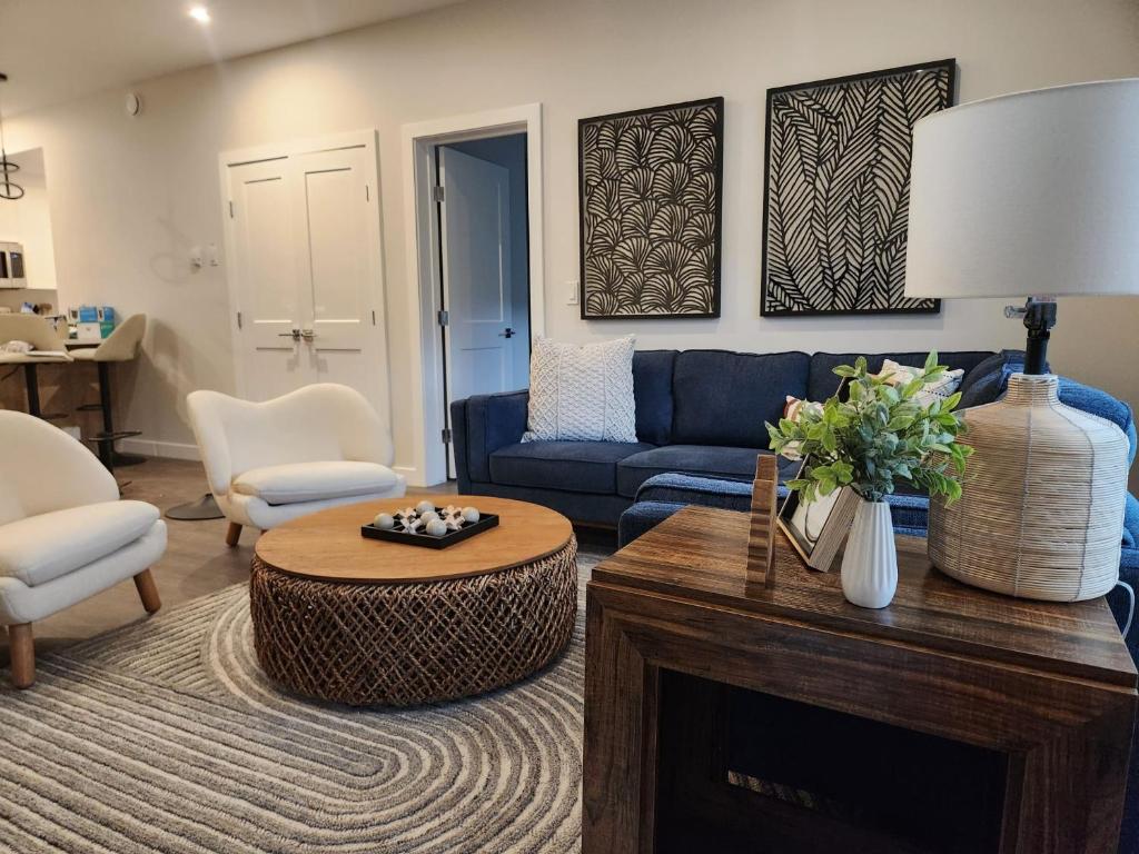 a living room with a blue couch and a table at Riverstone Retreat in Golden BC in Golden