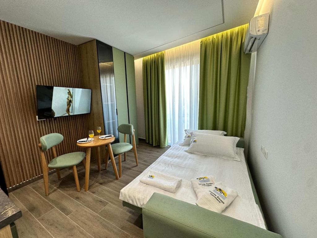 a hotel room with two beds and a table at Seaside Escape Apartment 1 in Golem