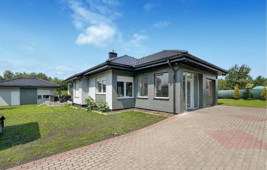 a house with a brick driveway in front of it at Amazing Home In Karlino in Karlino
